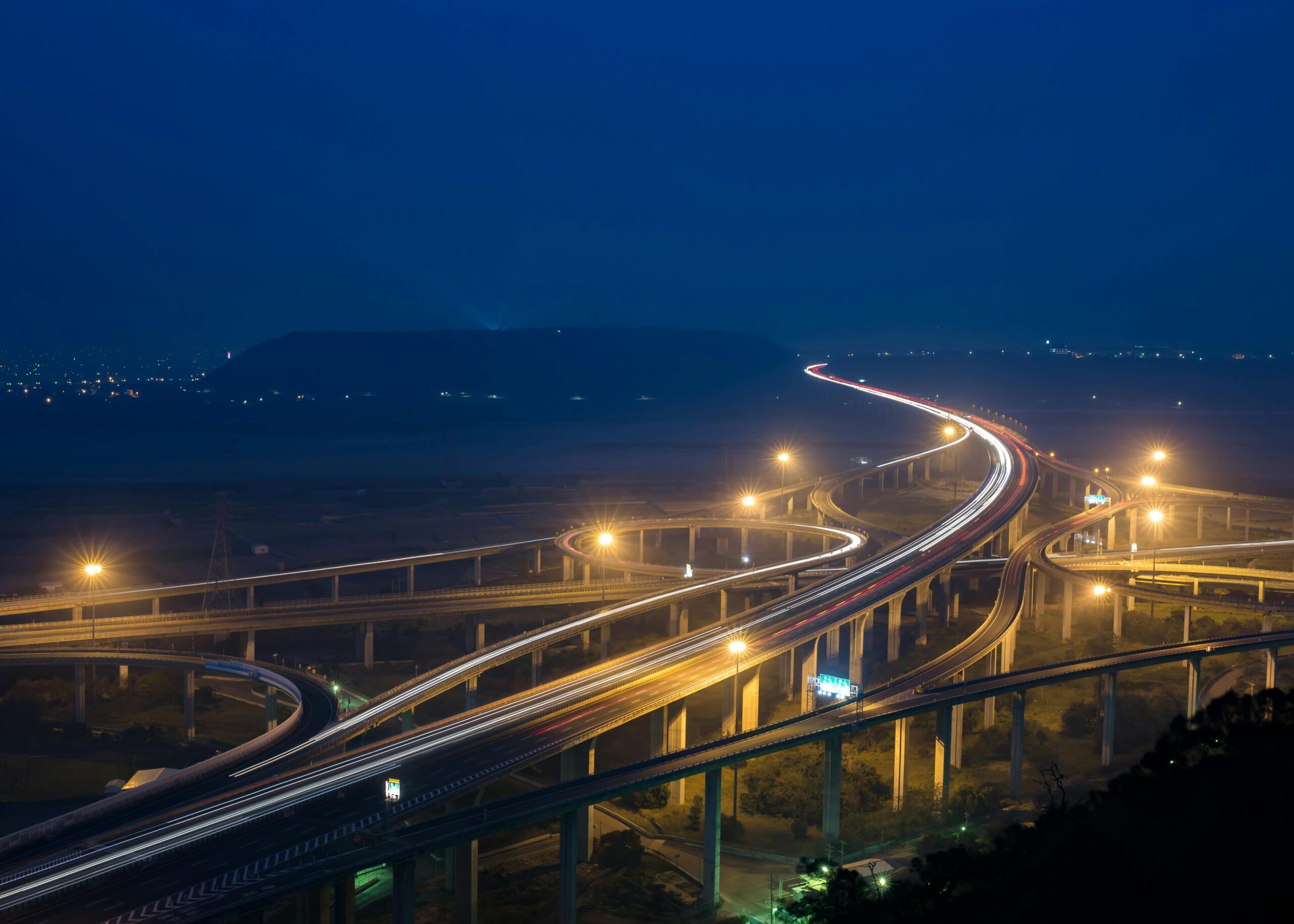 Multitude of roads crossing and junctions zig zagging at night with lights